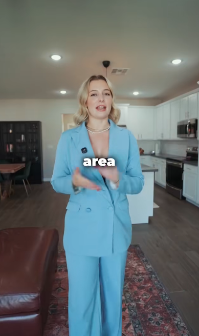 Miranda Radcliff speaking in a blue suit inside an Arizona listing